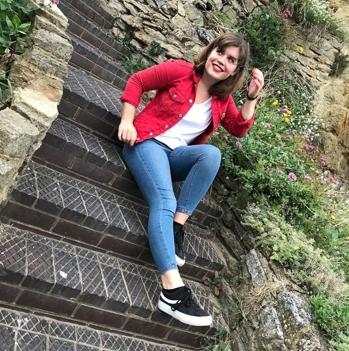 Bethany sitting outside on some steps