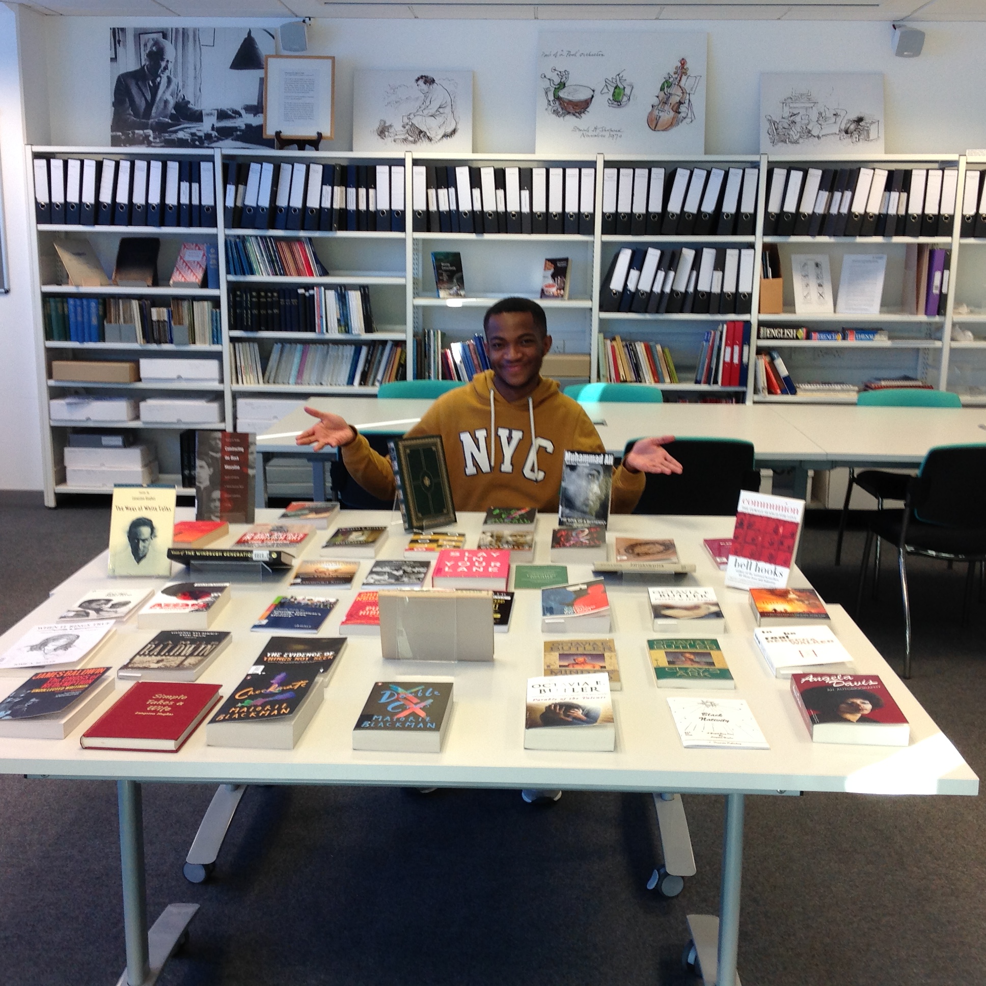 Joel sitting at table with books
